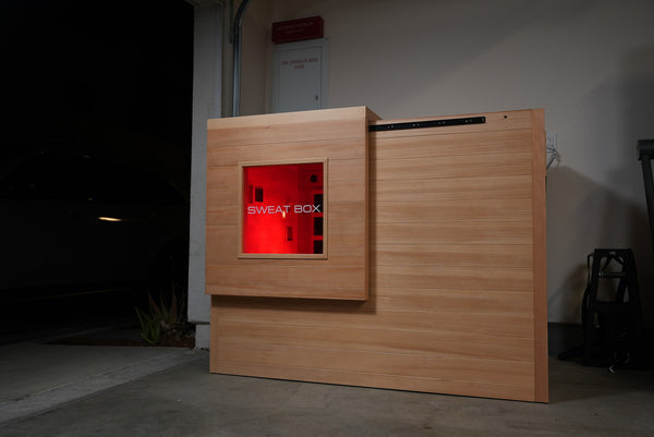 Window Edition sauna glowing red in a home garage
